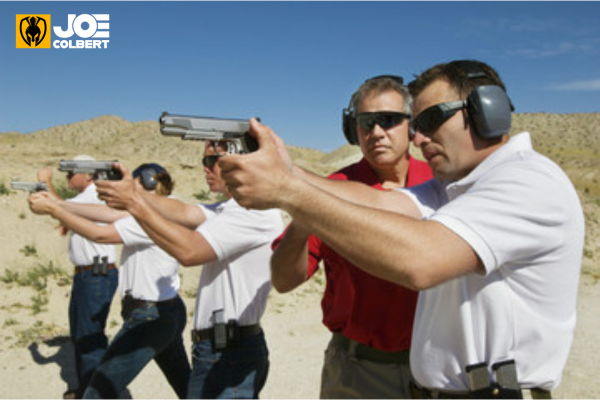 Picture of 4 students learning about handgun safety from an instructor