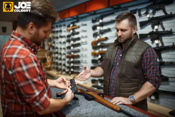 Picture of a gun store employee explaining guns to a potential customer