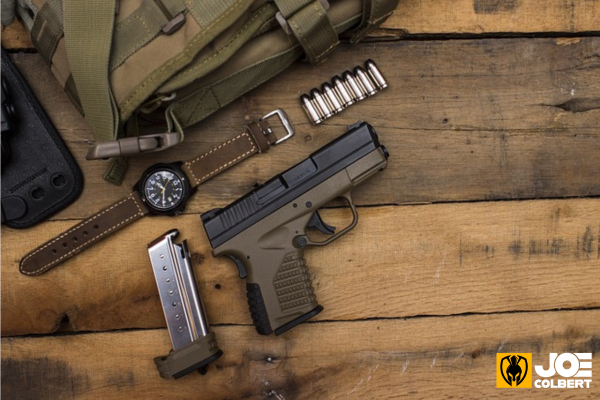 Picture of a handgun and some accessories on a table